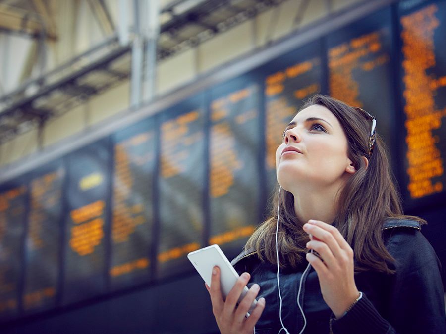 A woman looking up at the airport info board