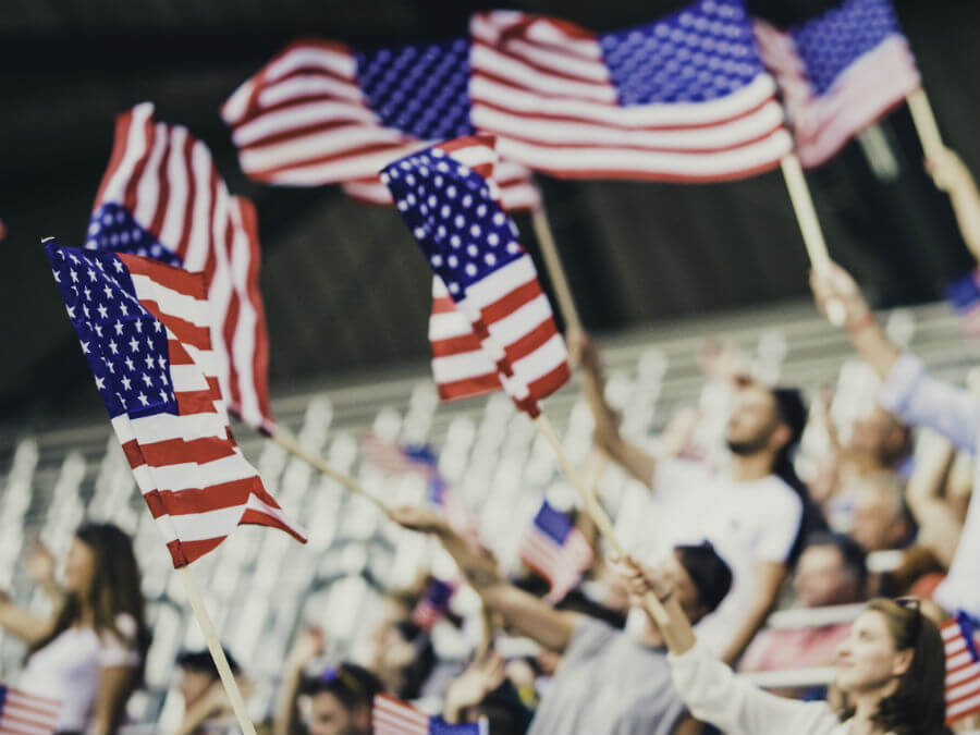 Crowd waving USA flags