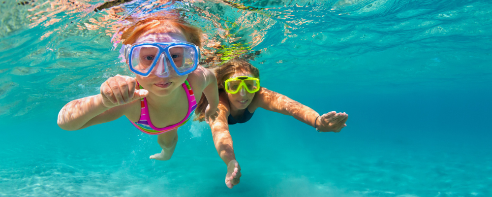 Two children snorkeling in the ocean