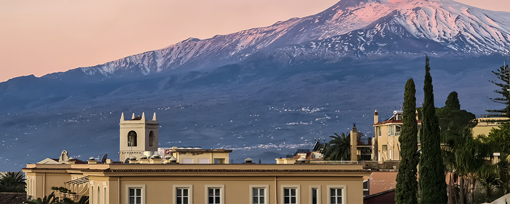 Historical building in front of mountain at sunset