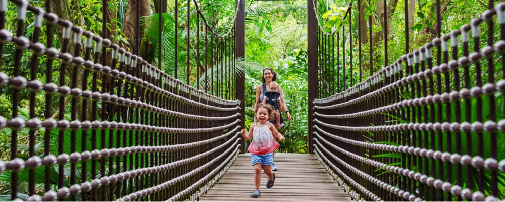 Girl running on suspension bridge in Jacob Ballas Children’s Garden