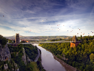 Hot air balloons over bridge